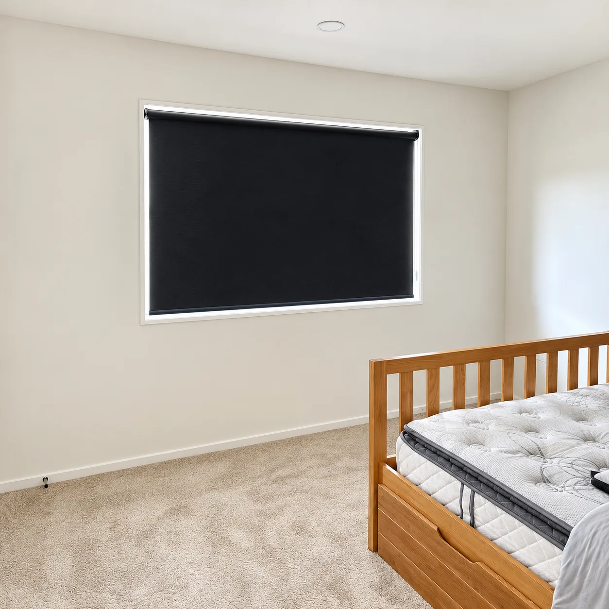 New-build bedroom with a black blockout roller blind