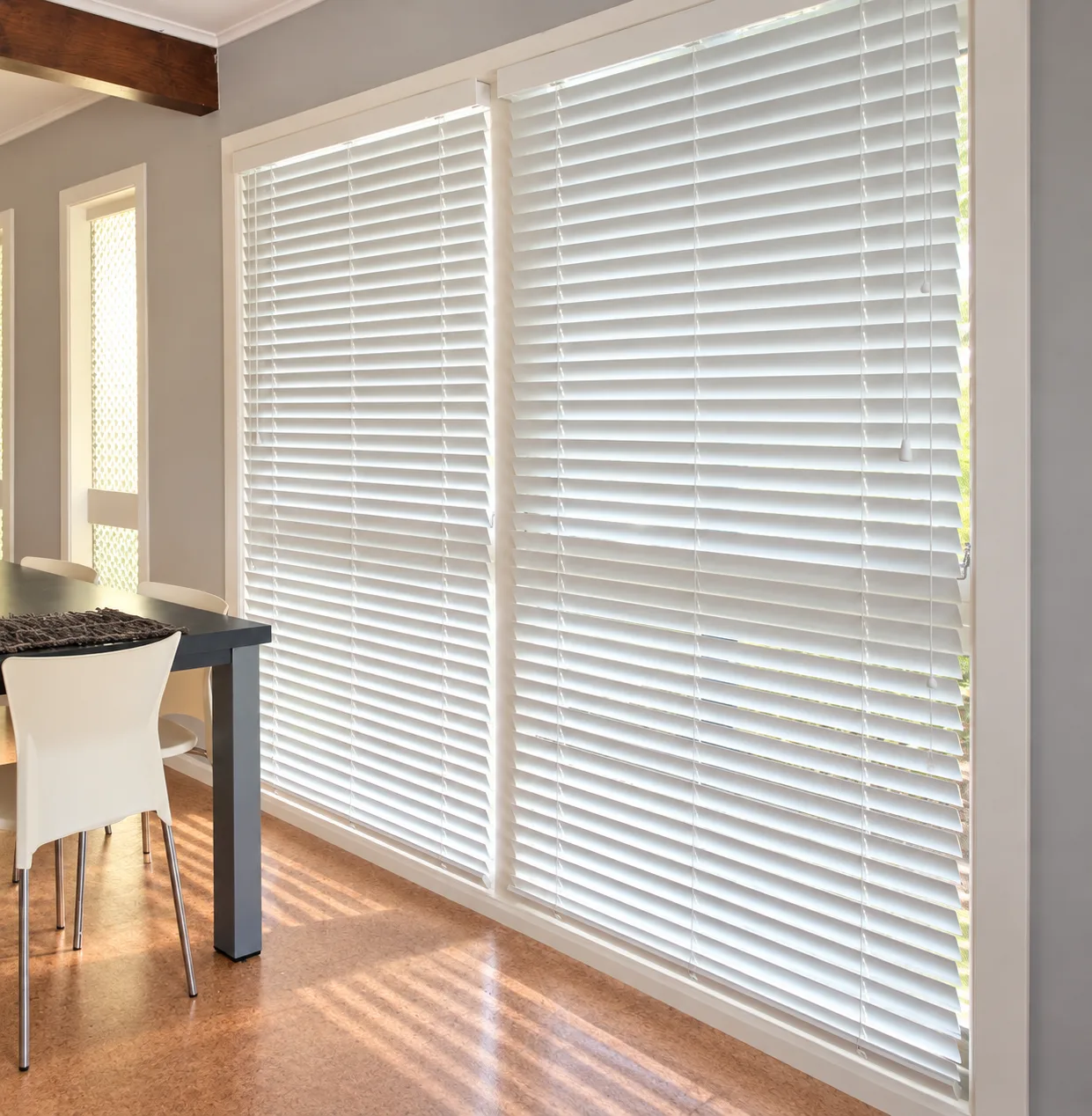 Dining room with white venetian blinds